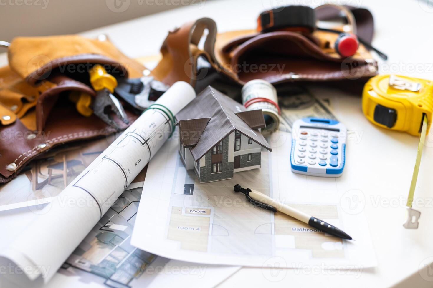 building house on blueprints with worker - construction project photo