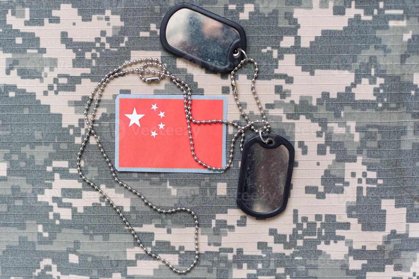 army blank, dog tag with flag china on the khaki texture background. military concept photo