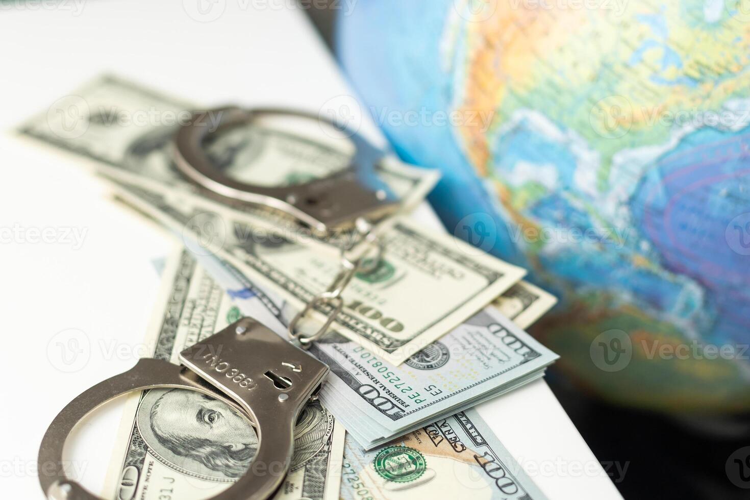 Map of world and Russia with pair of metal handcuffs. Arrest in Russian Federation and prison photo