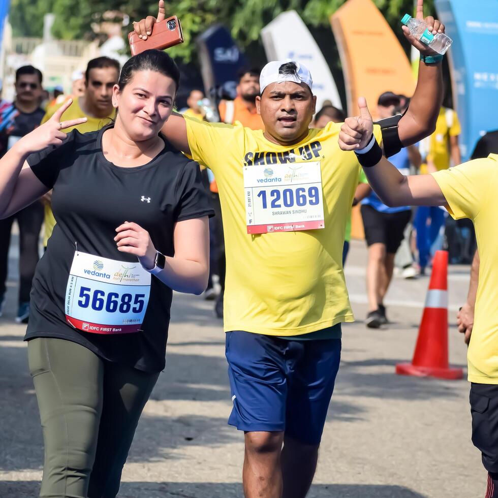 New Delhi, India - October 15 2023 - Vedanta Delhi Half Marathon race after covid in which marathon participants about to cross the finish line, Delhi Half Marathon 2023 photo