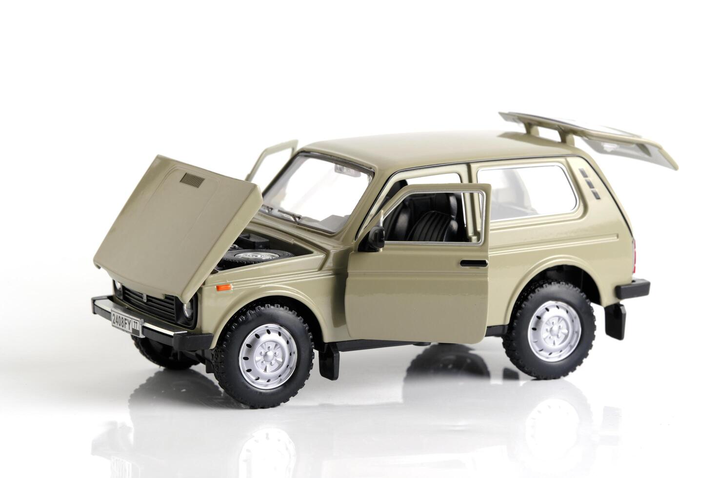 Kazakhstan, Kostanay, January 12, 2024. VAZ-2121 Lada Niva model in 1 24 scale on a white background. Russian SUV car. photo