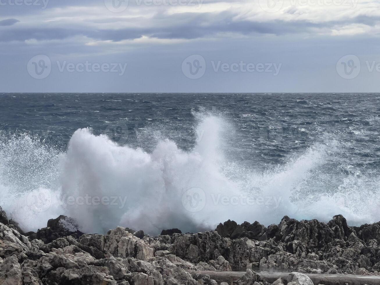 waves crashing on the rocks at the coast photo