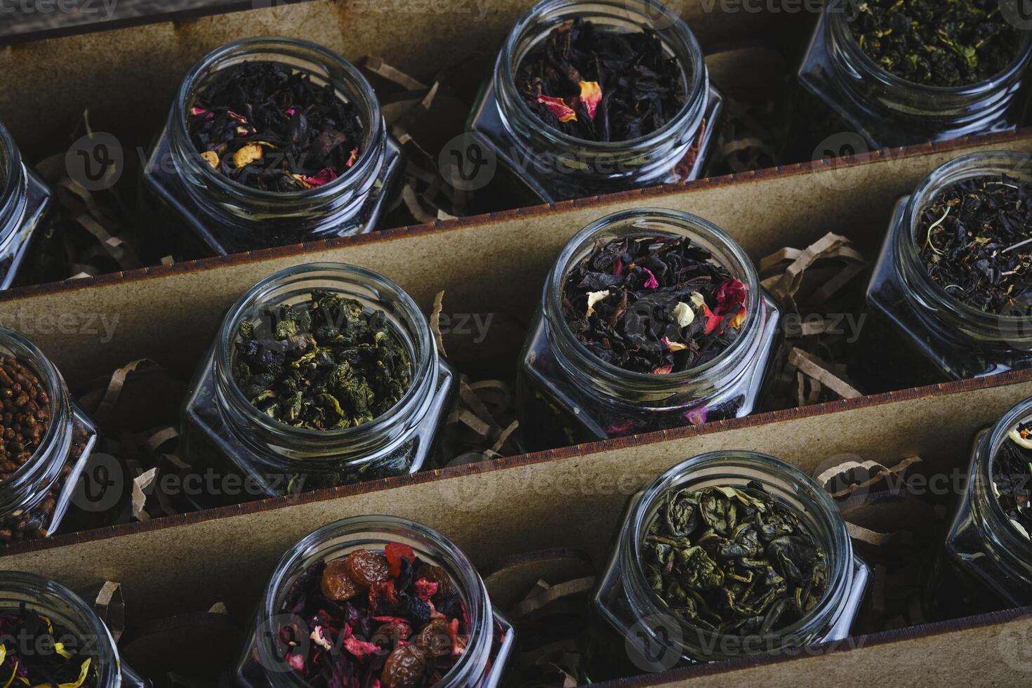 Set of various leaf tea packaged in jars. Black and green healthy tea with fruits, berries and herbs. photo