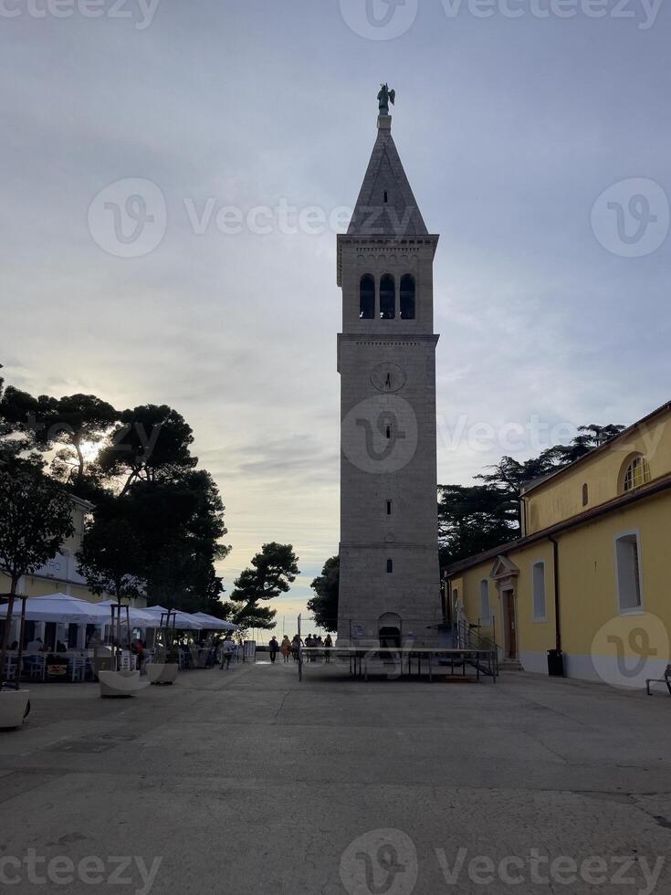 un grande reloj torre en un pueblo cuadrado foto