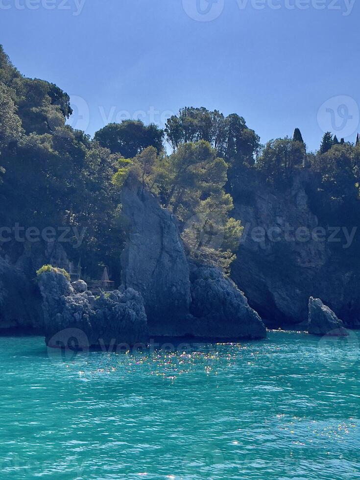 a body of water with a rocky shoreline photo