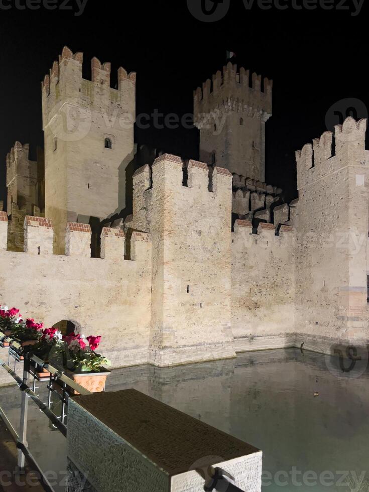 a castle with a lake photo