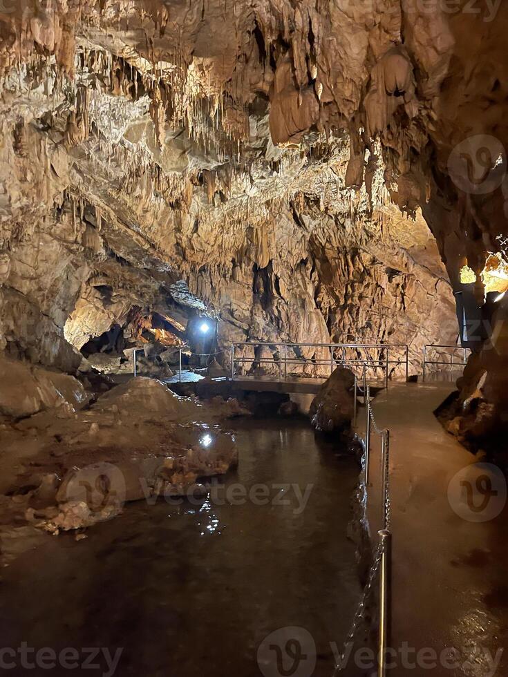 a cave with a walkway and a bridge photo