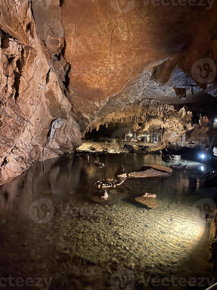 a cave with water and rocks in it photo