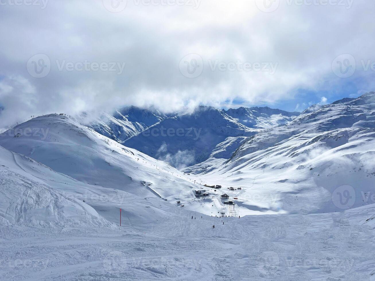 a snowy mountain with a ski slope photo