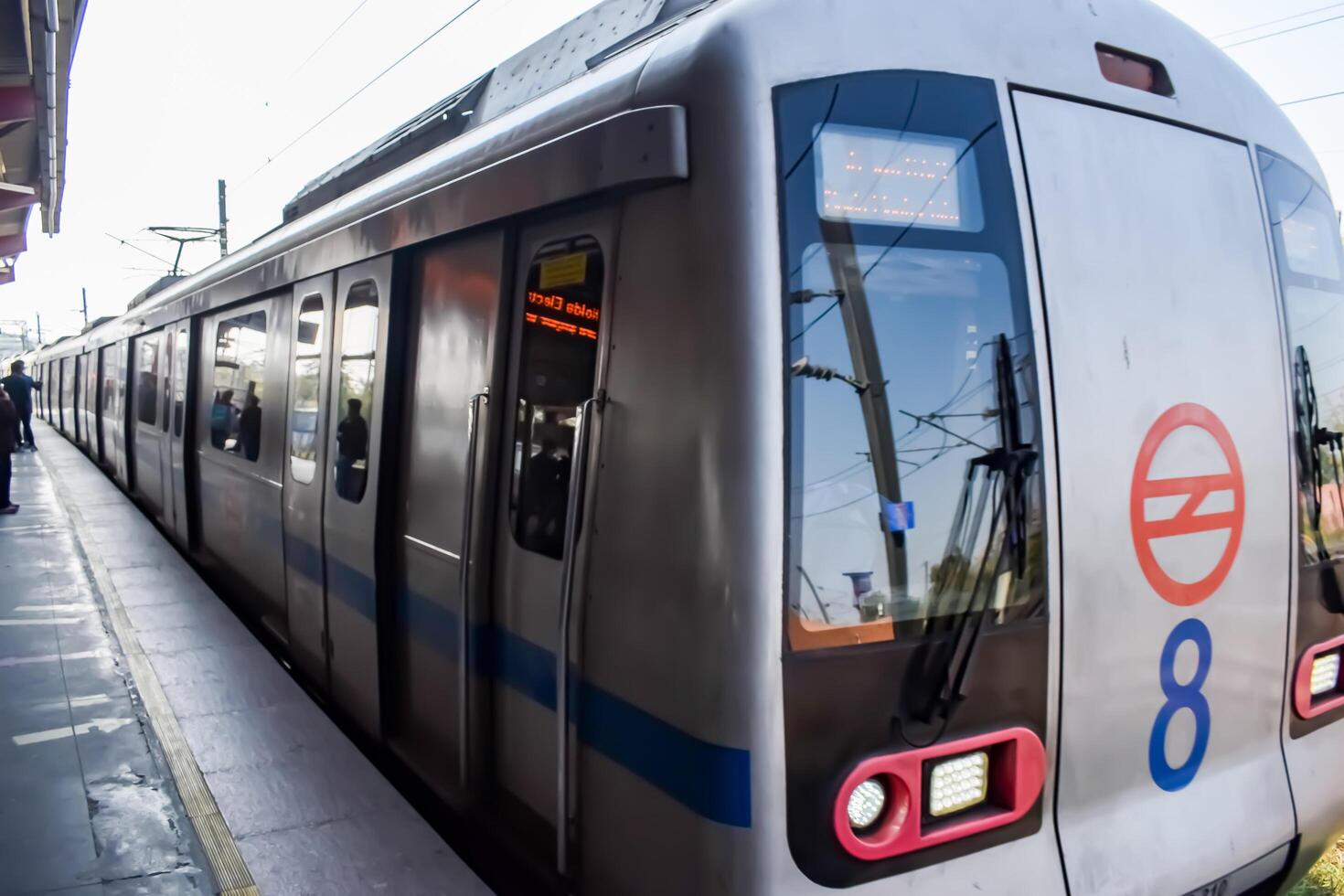 New Delhi, India, February 17 2024 - Delhi Metro train arriving at Jhandewalan metro station in New Delhi, India, Asia, Public Metro departing from Jhandewalan station photo