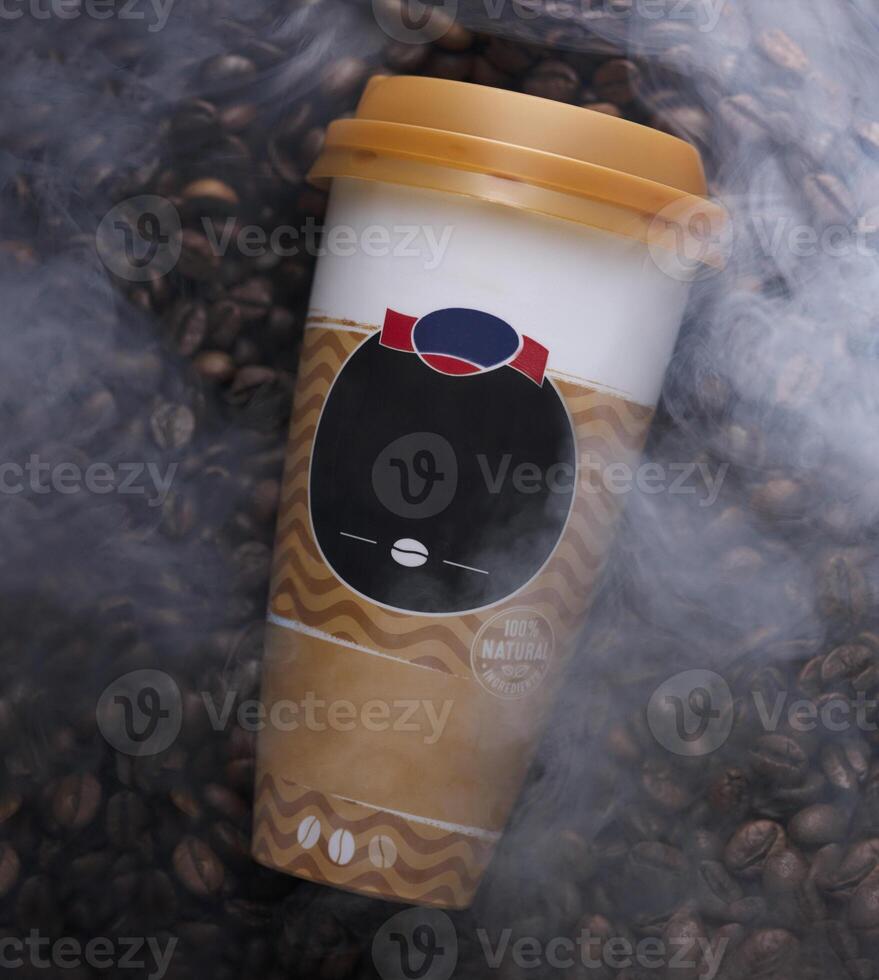 a coffee cup with a face on it is surrounded by coffee beans photo