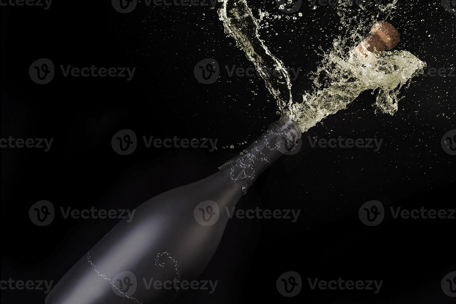 a bottle of champagne being splashed with water photo