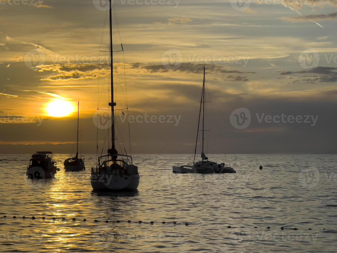 sailboat at sunset photo