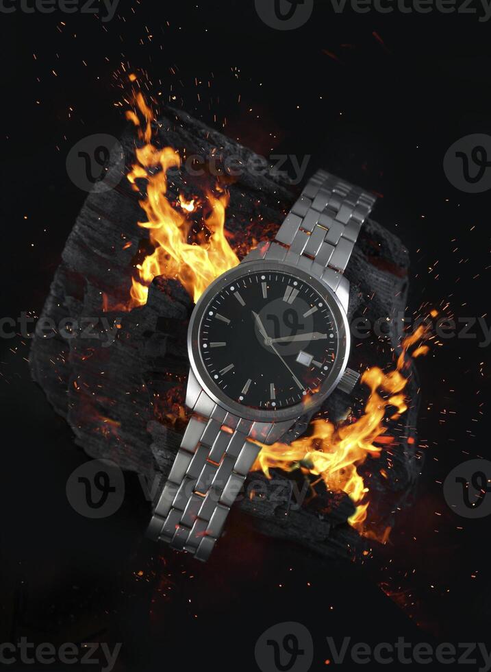 a watch with flames on a rock photo