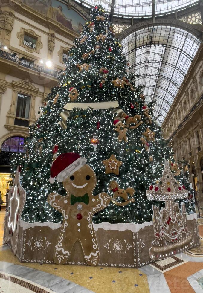 a large christmas tree in a mall with decorations photo