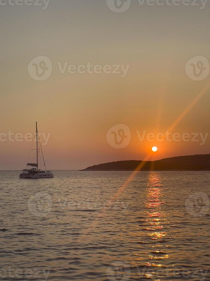 a boat is in the water at sunset photo