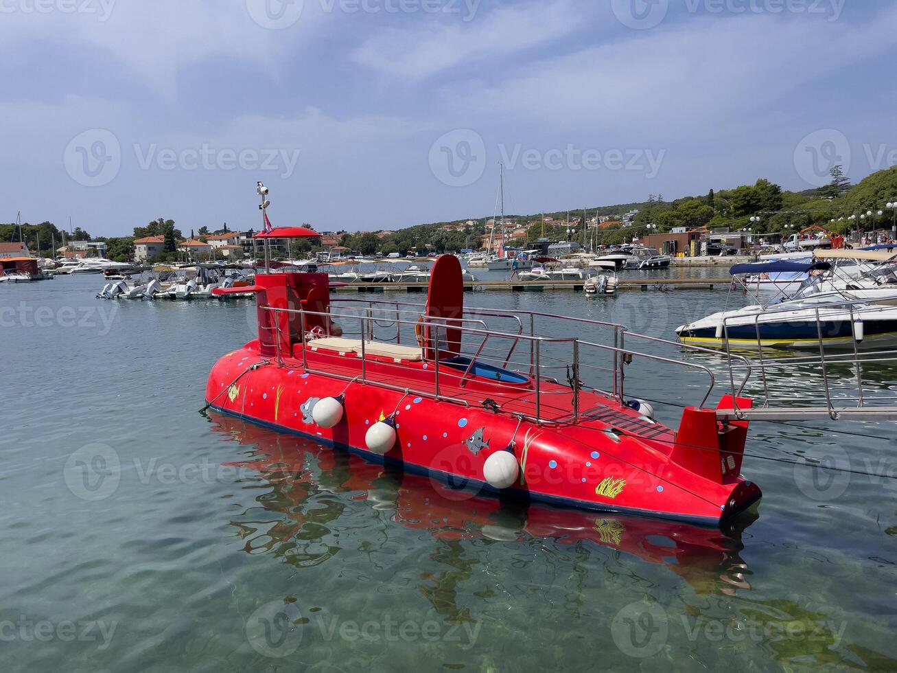 a red submarine in the water photo