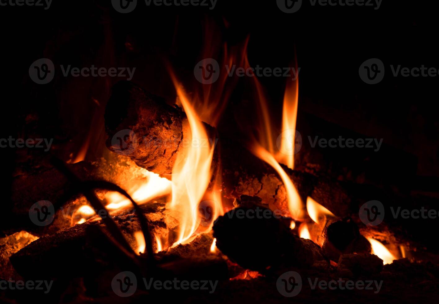 a fire burning in a fireplace with logs photo