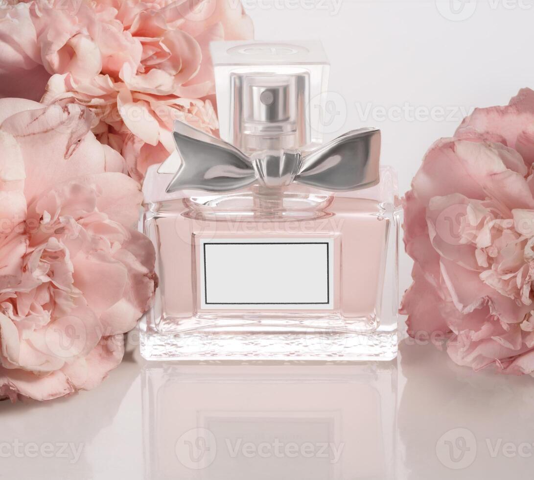 a perfume bottle with pink flowers and a bow photo