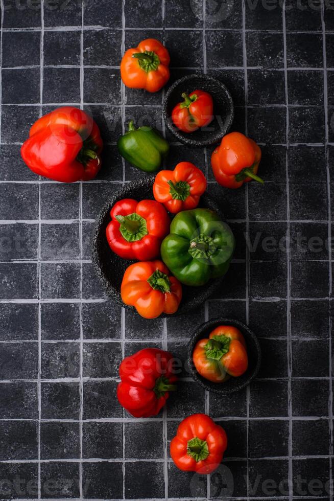 Colorful bell pepper on black background photo