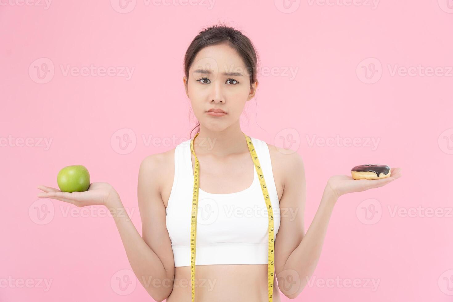 slim body Women choose during healthy foods and junk food, female choose green apple for diet. Good healthy food. weight lose, balance, control, reduce fat, low calories, routines, exercise. photo
