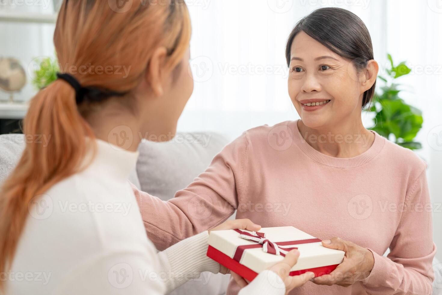 Mother day, cute asian teen girl give gift box to mature middle age mum. Love, kiss, care, happy smile enjoy family time. celebrating special occasion, happy birthday, happy new years, merry Christmas photo
