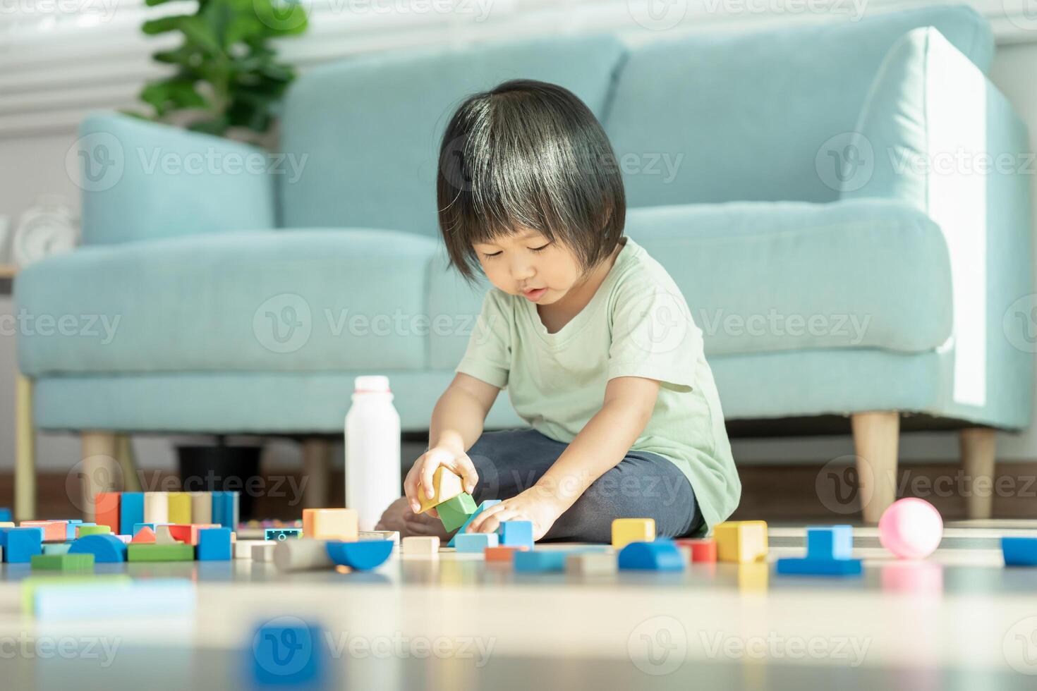 Happy Asian child playing and learning toy blocks. children are very happy and excited at home. child have a great time playing, activities, development, attention deficit hyperactivity disorder photo