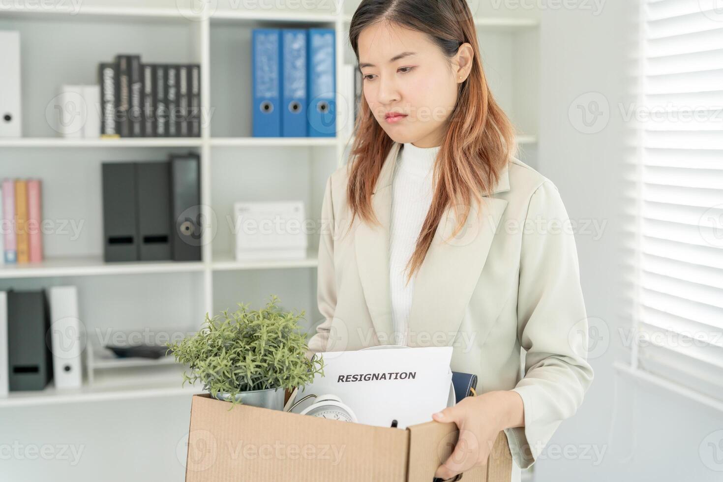 resignation, leave, quit, Stressful businesswomen will resign from the company. Female staff is lifting a brown paper box that holds personal items. , job placement and vacancies, resignation letter photo