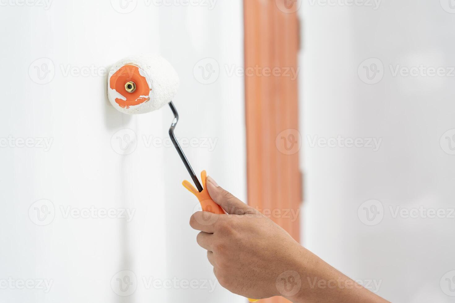 painter man, brush in hand for products to restore and paint the wall, indoor the building site of a house, wall during painting, renovation, painting, contractor, Architect, construction worker photo