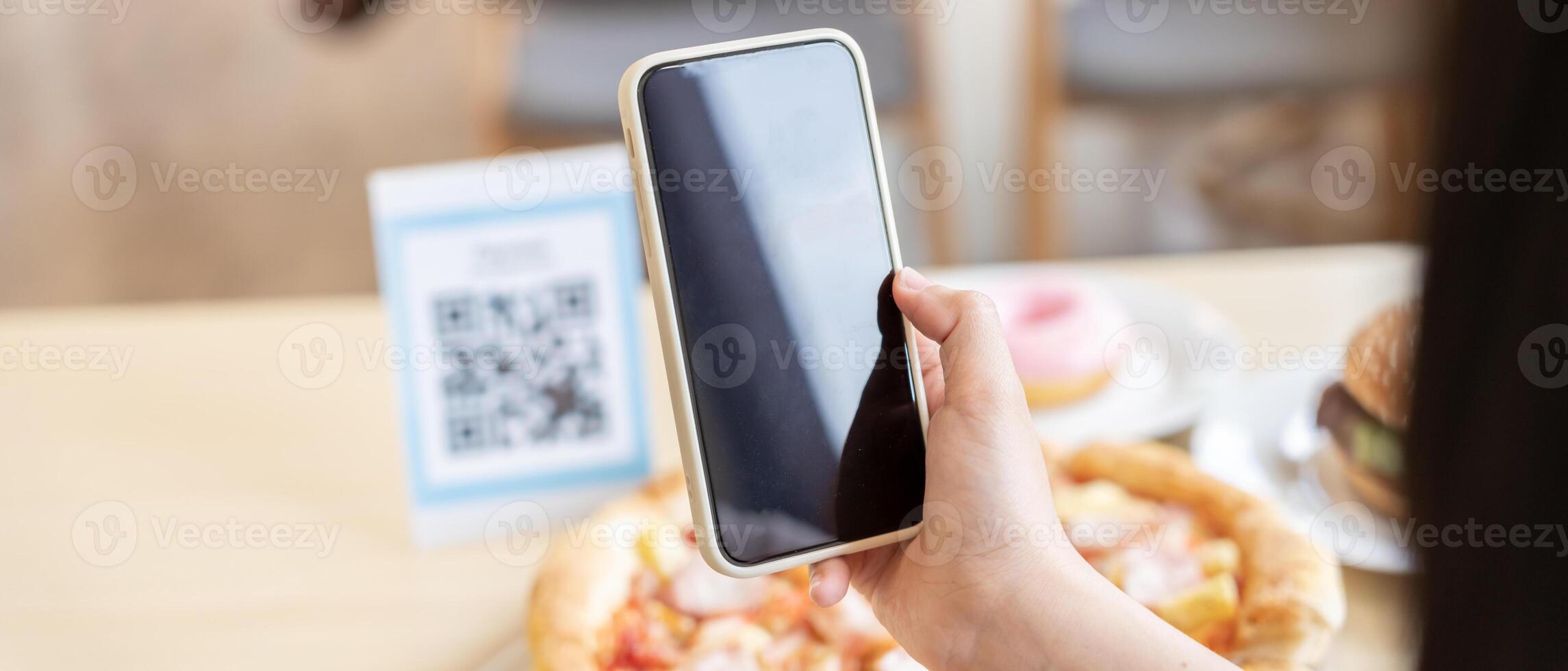 Woman use smartphone to scan QR code to pay in cafe restaurant with a digital payment without cash. Choose menu and order accumulate discount. E wallet, technology, pay online, credit card, bank app photo
