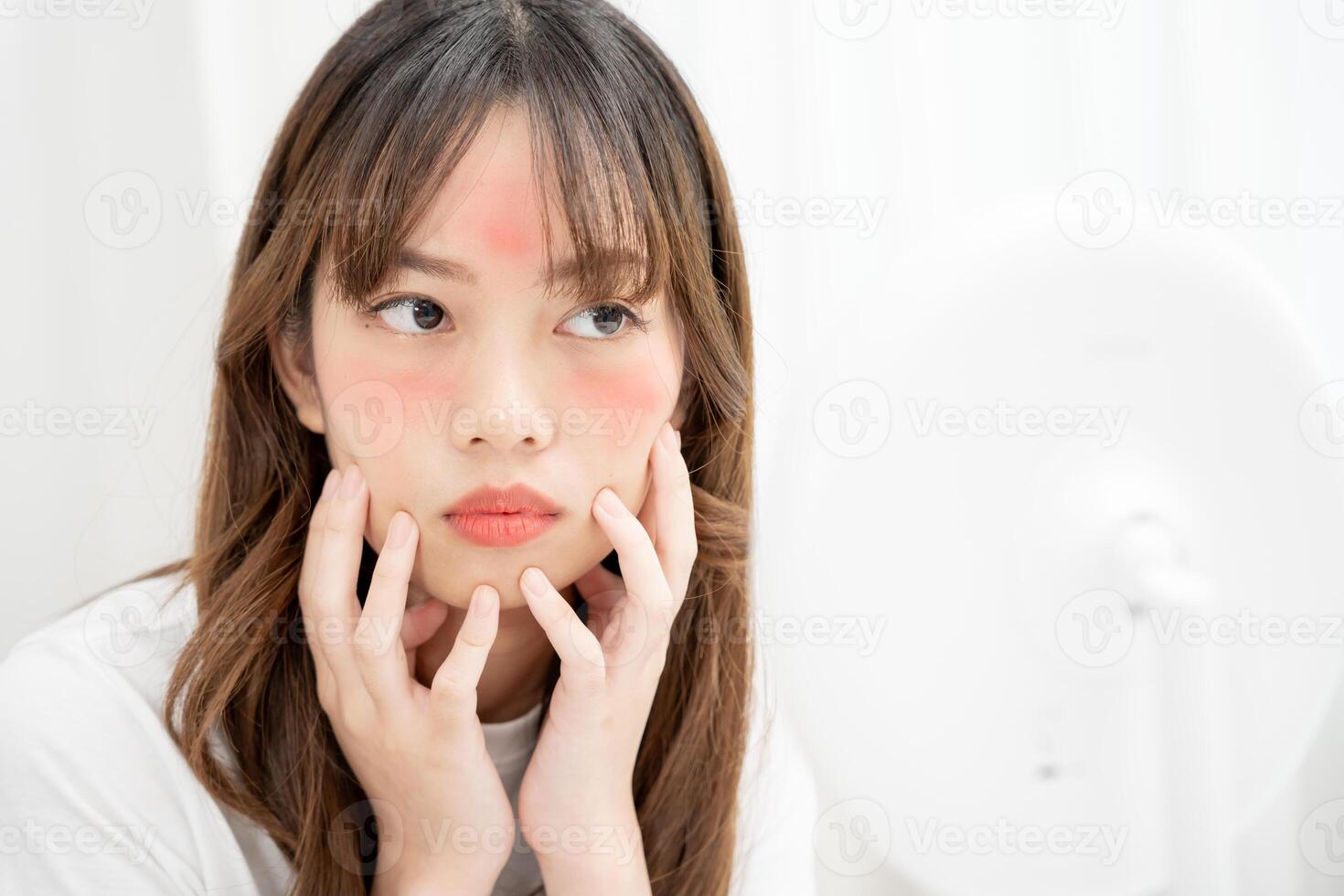 Young woman are worried about faces Dermatology and allergic to steroids in cosmetics. sensitive skin, red face from sunburn, acne, allergic to chemicals, rash on face. skin problems and beaut photo