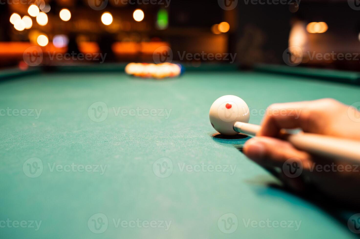 Man preparing to break spheres in billiard photo