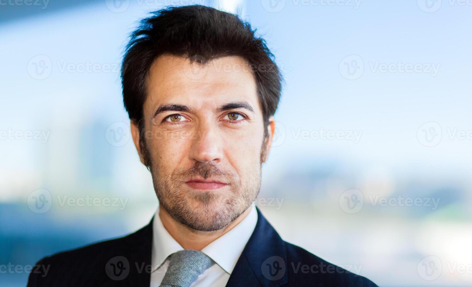 Handsome smiling businessman in his office photo