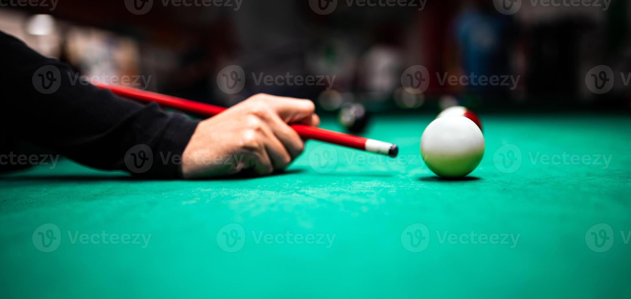 Young man playing snooker, aiming. for a good shot photo