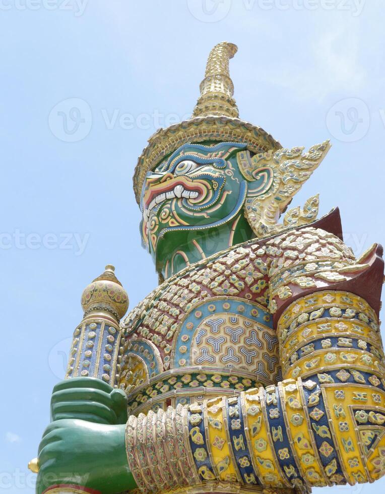 statue of buddha on the background of blue sky. giants front of the church at Wat Arun Temple. Thailand photo