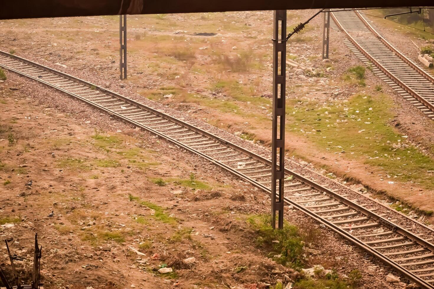View of train Railway Tracks from the middle during daytime at Kathgodam railway station in India, Toy train track view, Indian Railway junction, Heavy industry photo