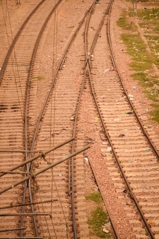 View of train Railway Tracks from the middle during daytime at Kathgodam railway station in India, Toy train track view, Indian Railway junction, Heavy industry photo