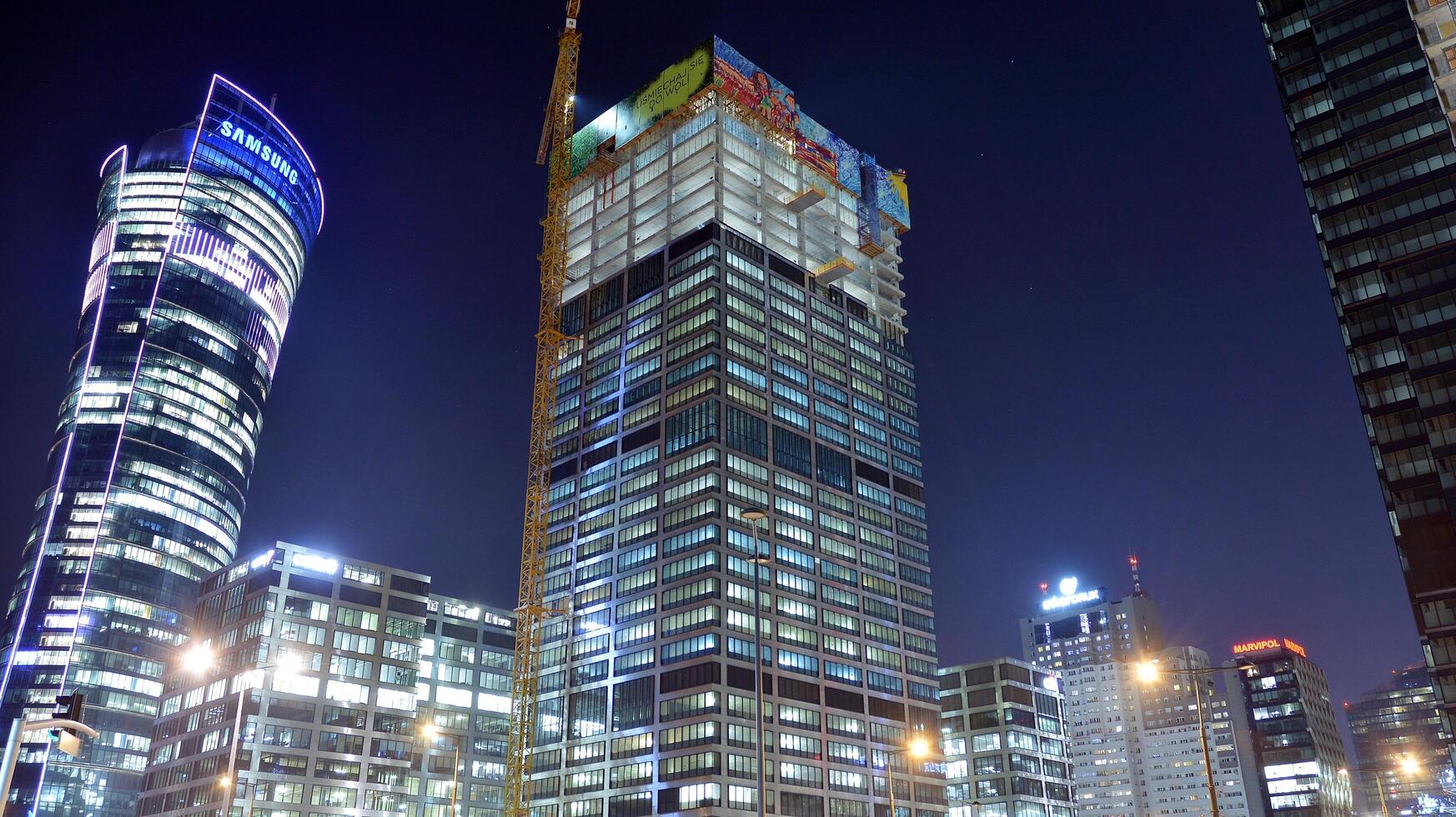 Pattern of office buildings windows illuminated at night. Glass architecture ,corporate building at night - business concept. Blue graphic filter. photo