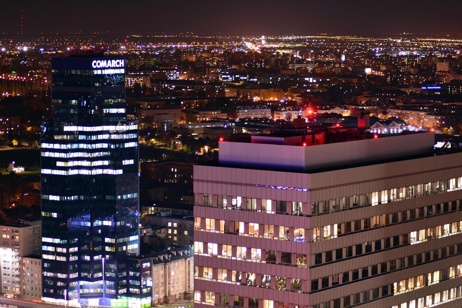 View of at night glass buildings and modern business skyscrapers. View of modern skyscrapers and  business buildings in downtown. Big city at night. photo