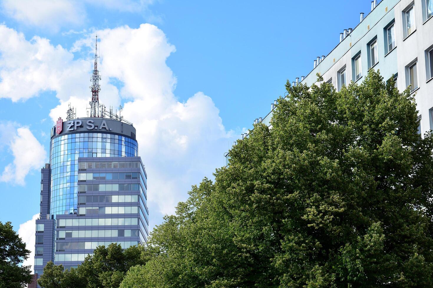 Glass building with transparent facade of the building and blue sky. Structural glass wall reflecting blue sky. Abstract modern architecture fragment. Contemporary architectural background. photo