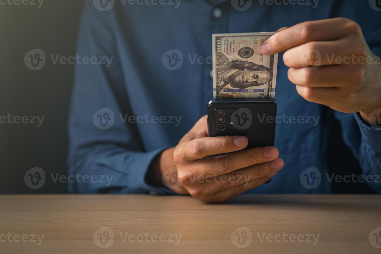 Global Economic and exchange rate on currency stock market. business man holding banknote and using phone  for US dollar index concept. photo