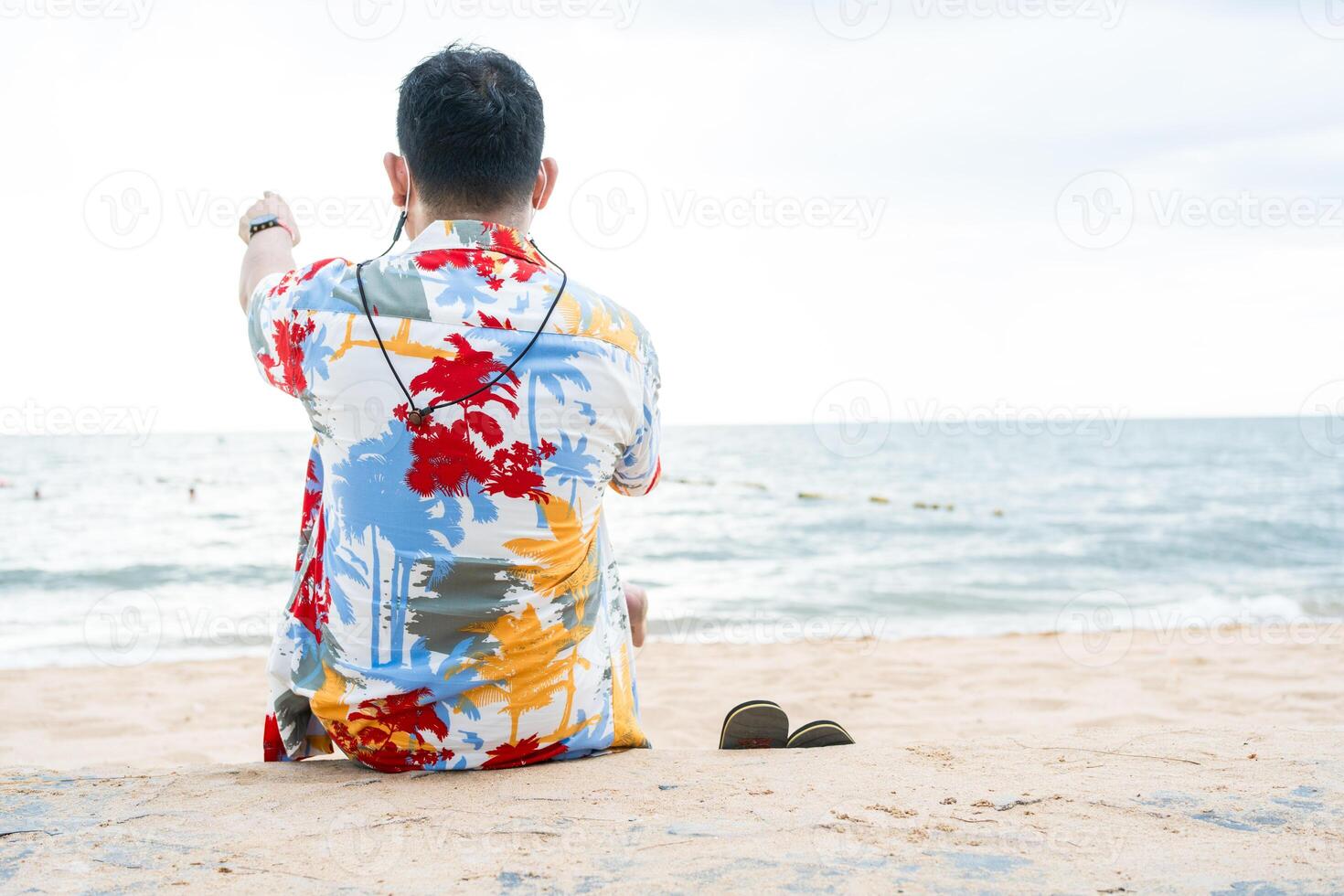 Young man admiring the sea and looks out to sea from coastal. photo