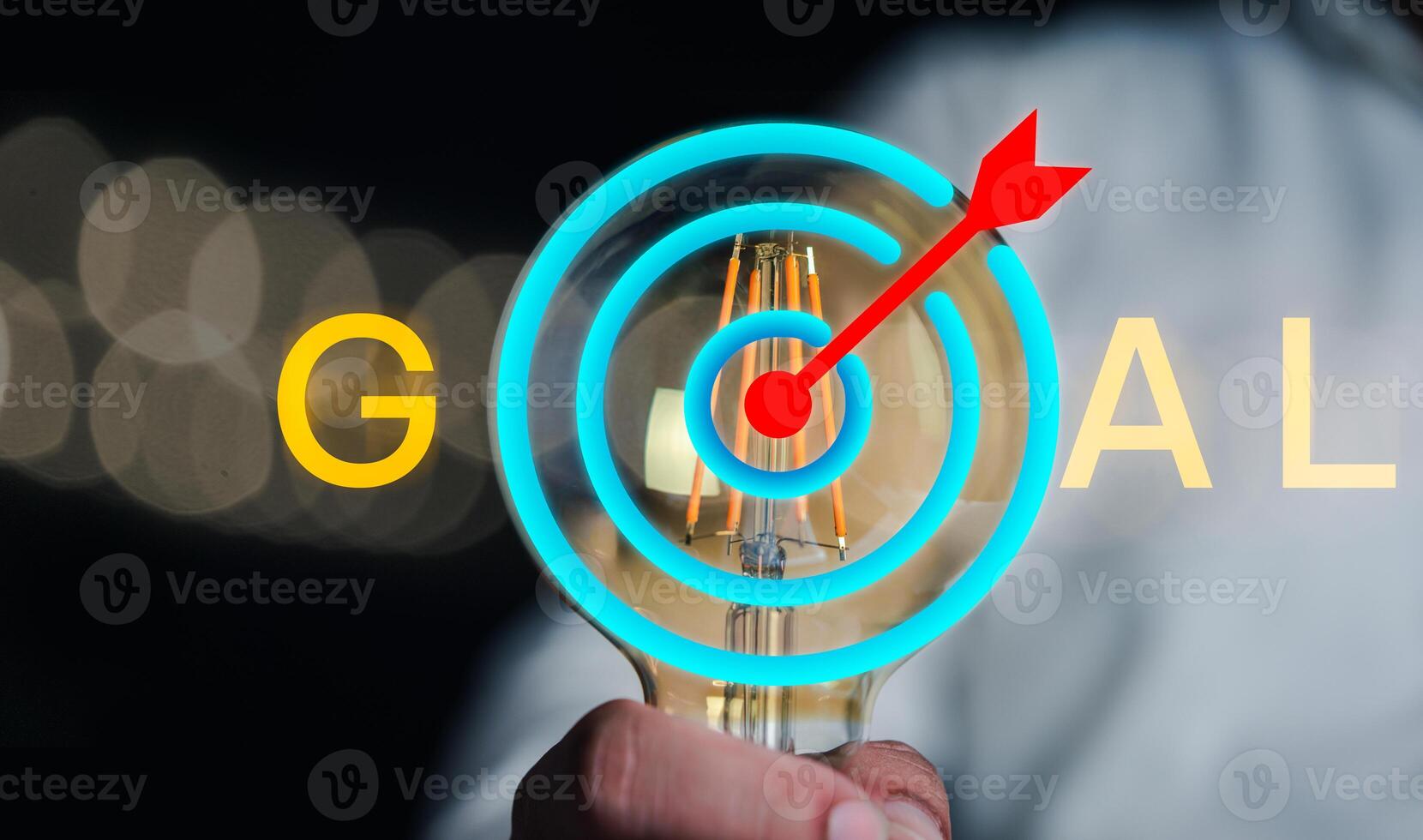 Hand holding Illuminated light bulb with goal icon to the goal. Action business plan targets to the goal photo