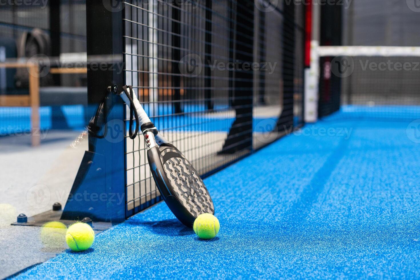 White professional paddle tennis racket with natural lighting on blue background. Horizontal sport theme poster, greeting cards, headers, website and app photo