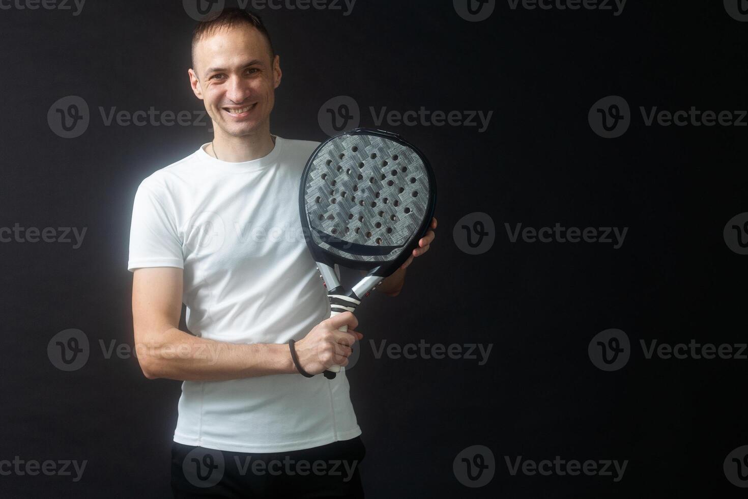 Padel Tennis Player with Racket in Hand. Paddle tennis, on a black background. photo