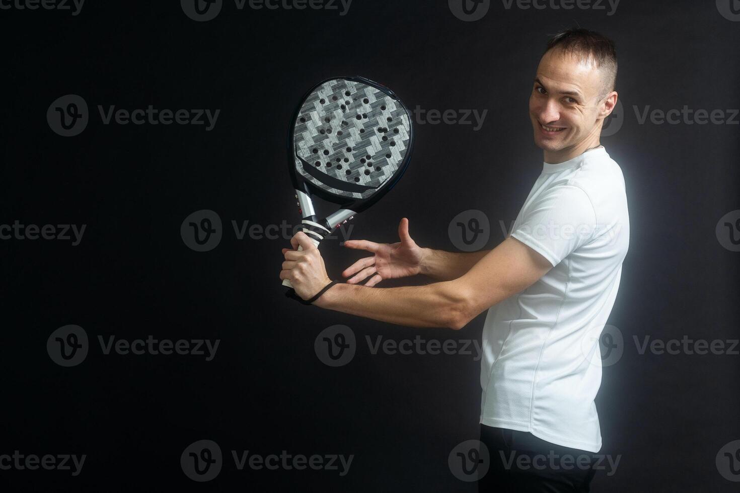 Padel Tennis Player with Racket in Hand. Paddle tennis, on a black background. photo