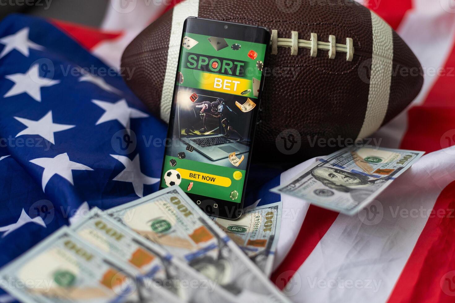 Online sports betting. Dollars are falling on the background of a hand with a smartphone and a soccer ball. Creative background, gambling photo