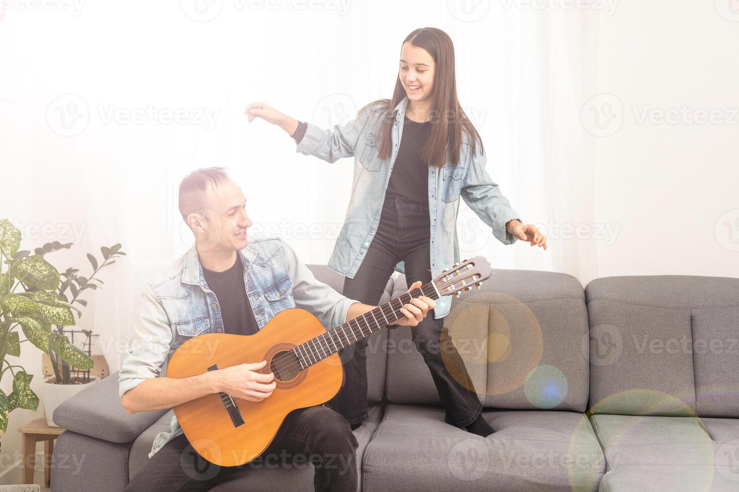 Happy family Father and daughter playing guitar. Father's day. photo