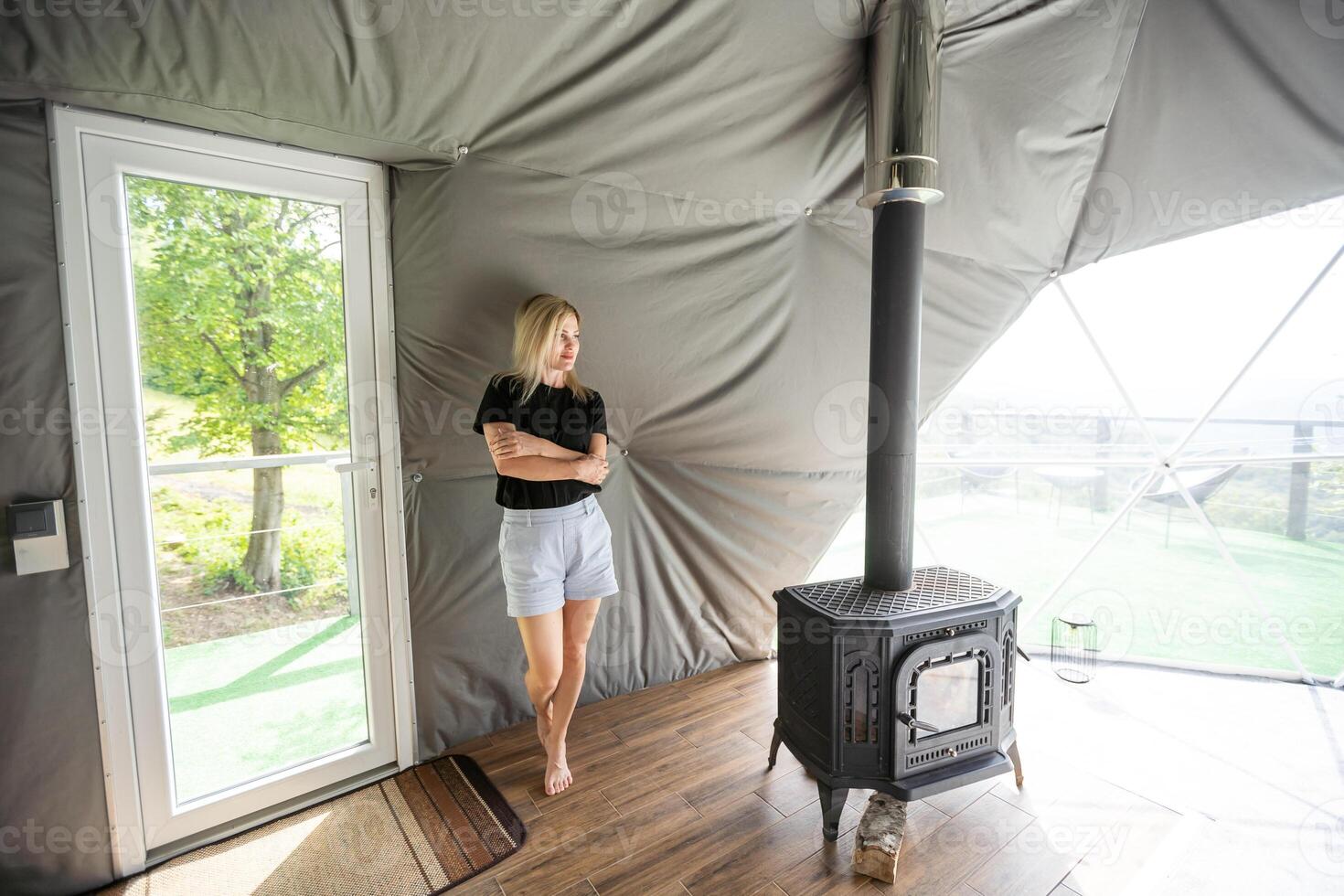 woman in dome tent. Glamping vacation lifestyle concept. photo
