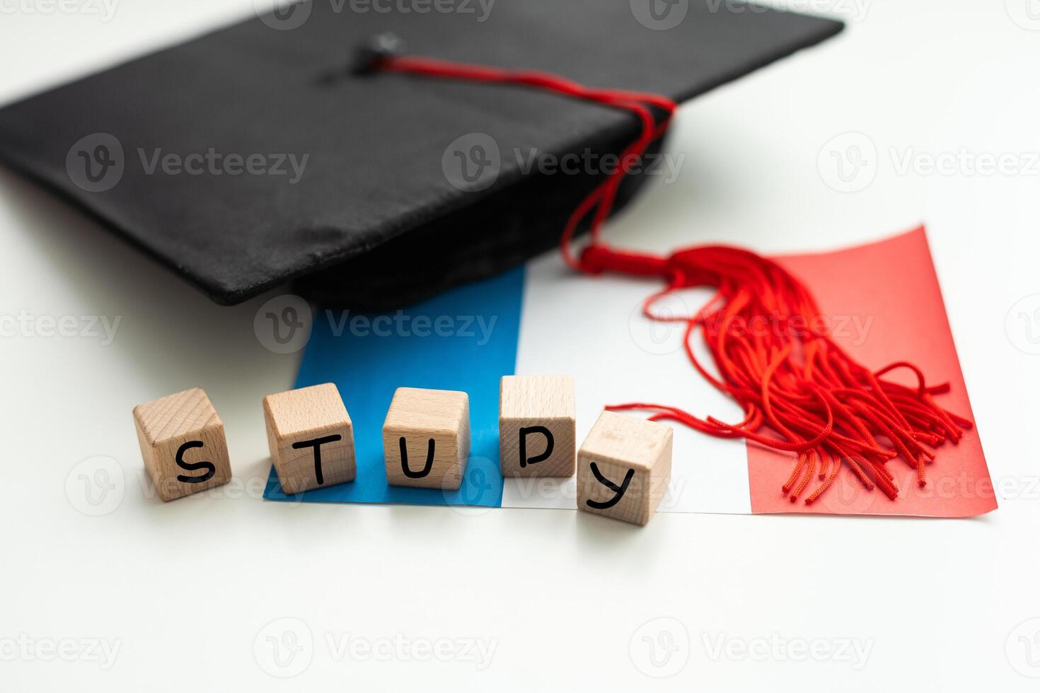 Graduation gap hat and wooden cubes, Education study testing learning teach concept. photo